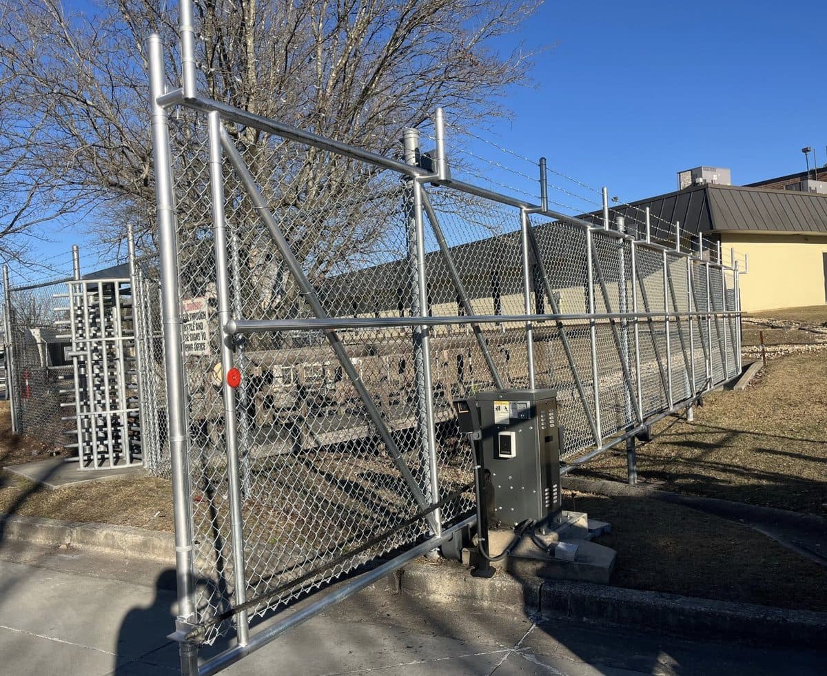 Chain link slide gate with operator and barbed wire in Georgia