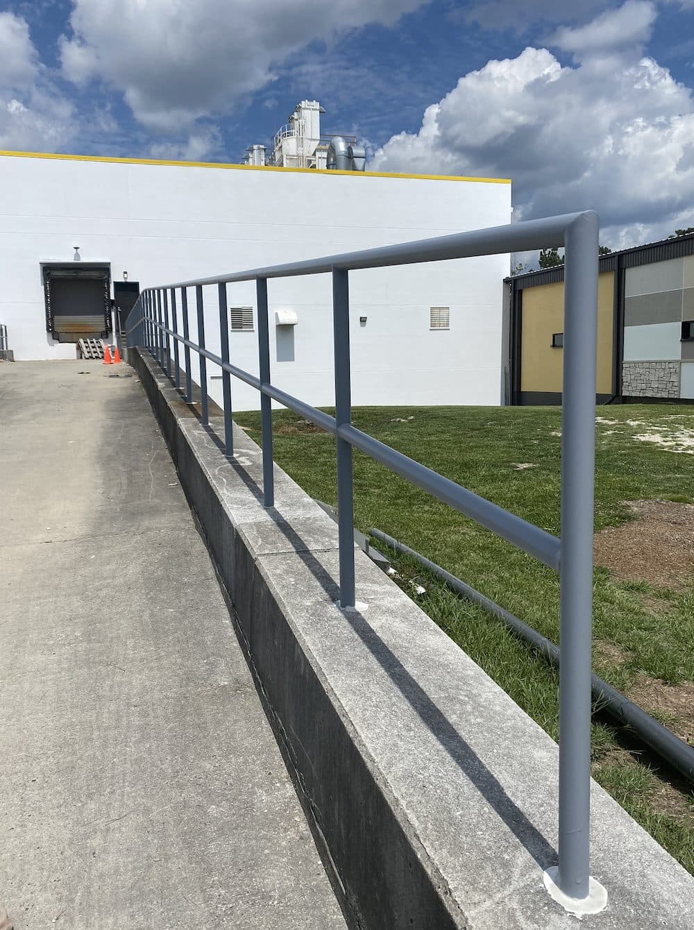 Industrial safety railing along concrete wall in Georgia